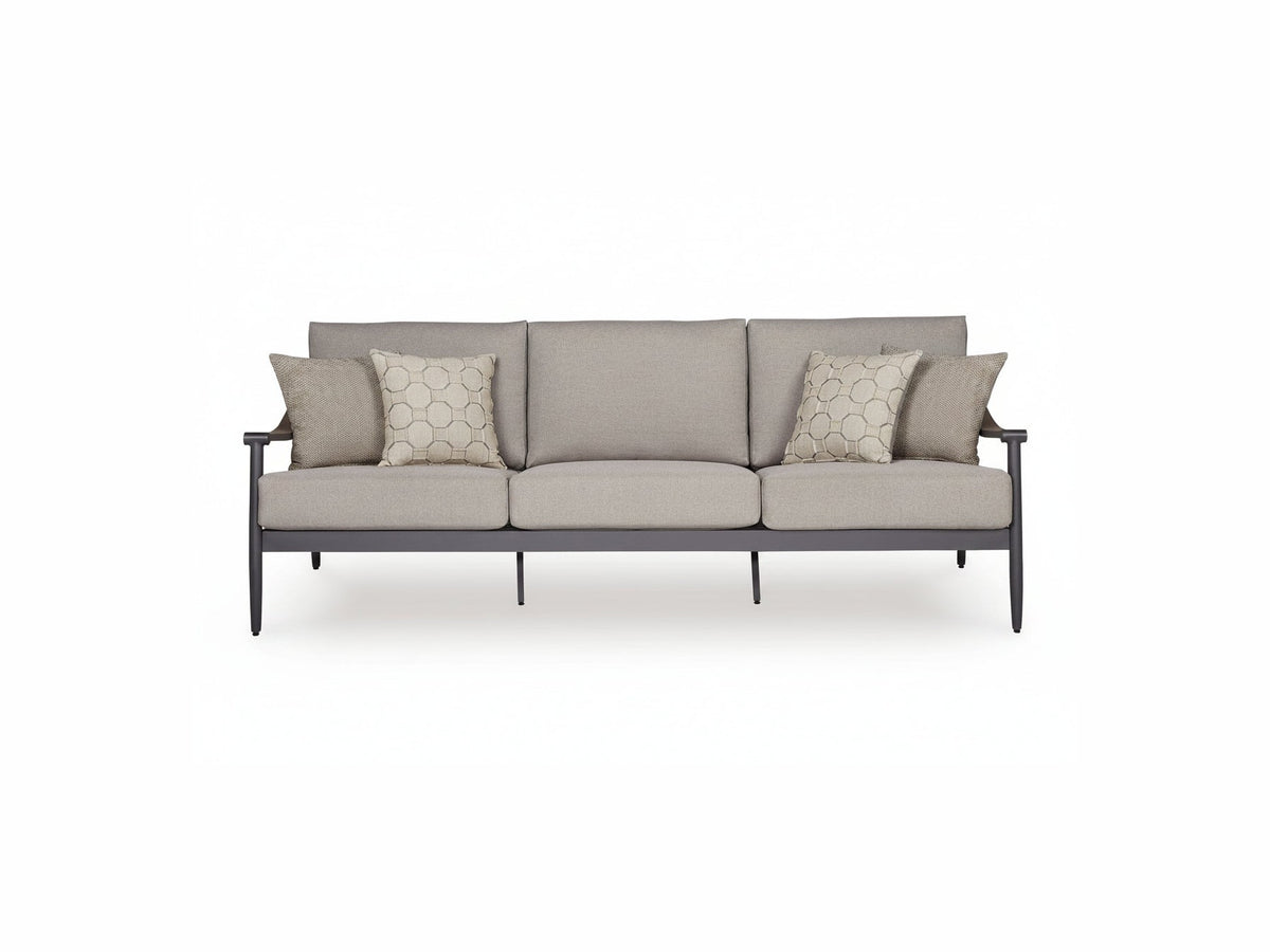 Gray sofa with patterned cushions on a white background