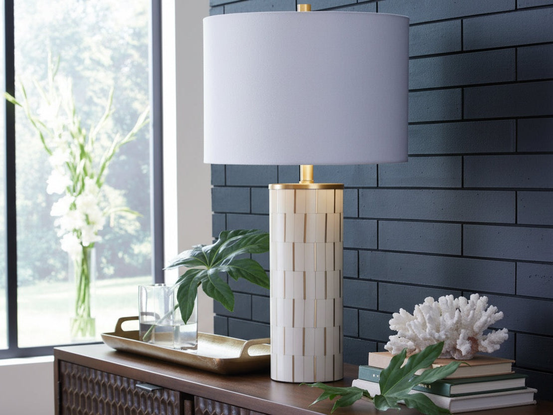 Faridworth table lamp with a white cylindrical base and gray shade on a decorative surface.
