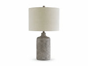Linus table lamp with textured base and beige fabric shade on a white background