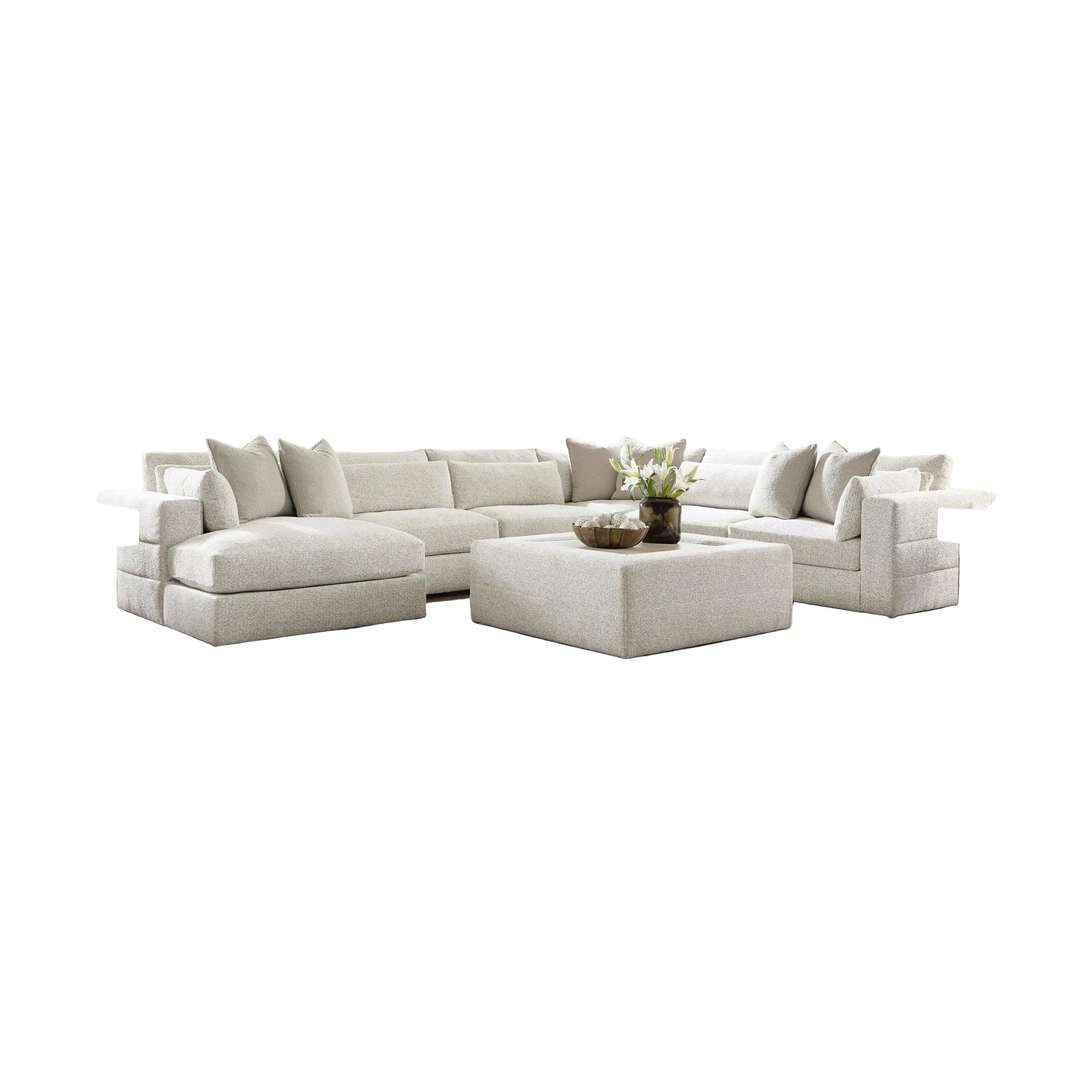 Modern living room with a large sectional sofa, coffee table, and decorative elements.