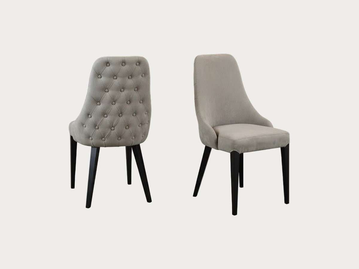 Two Luna gray upholstered chairs with black legs on a gradient background