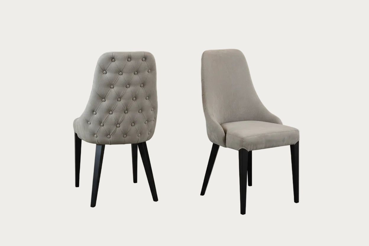 Two Luna gray upholstered chairs with black legs on a gradient background