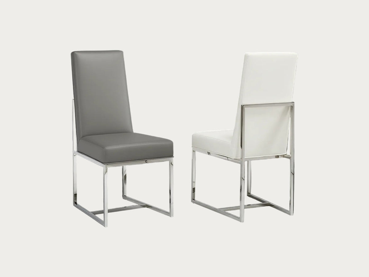 Two Bess chairs, one with a gray cushion and the other with a white cushion, on a dark background.