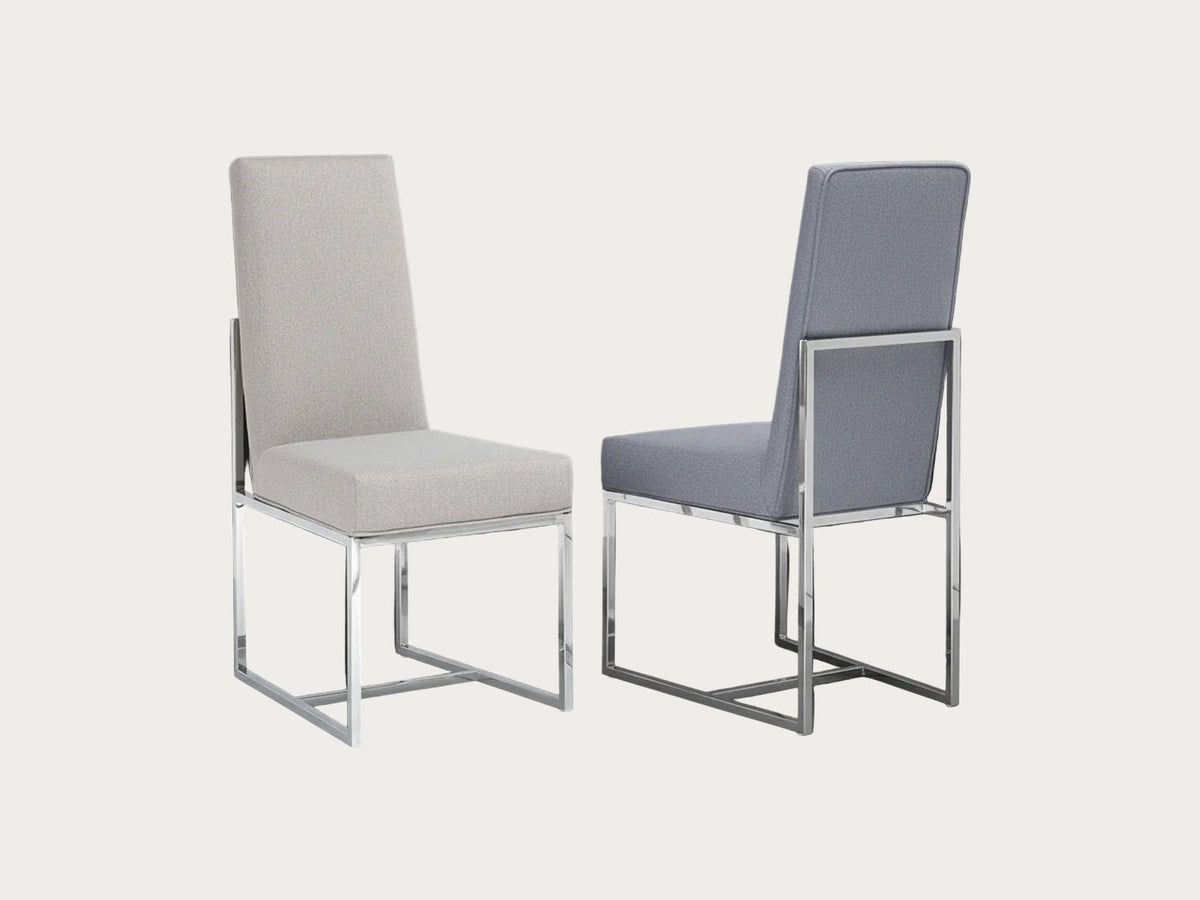 Two Bess chairs with metal frames on a dark background