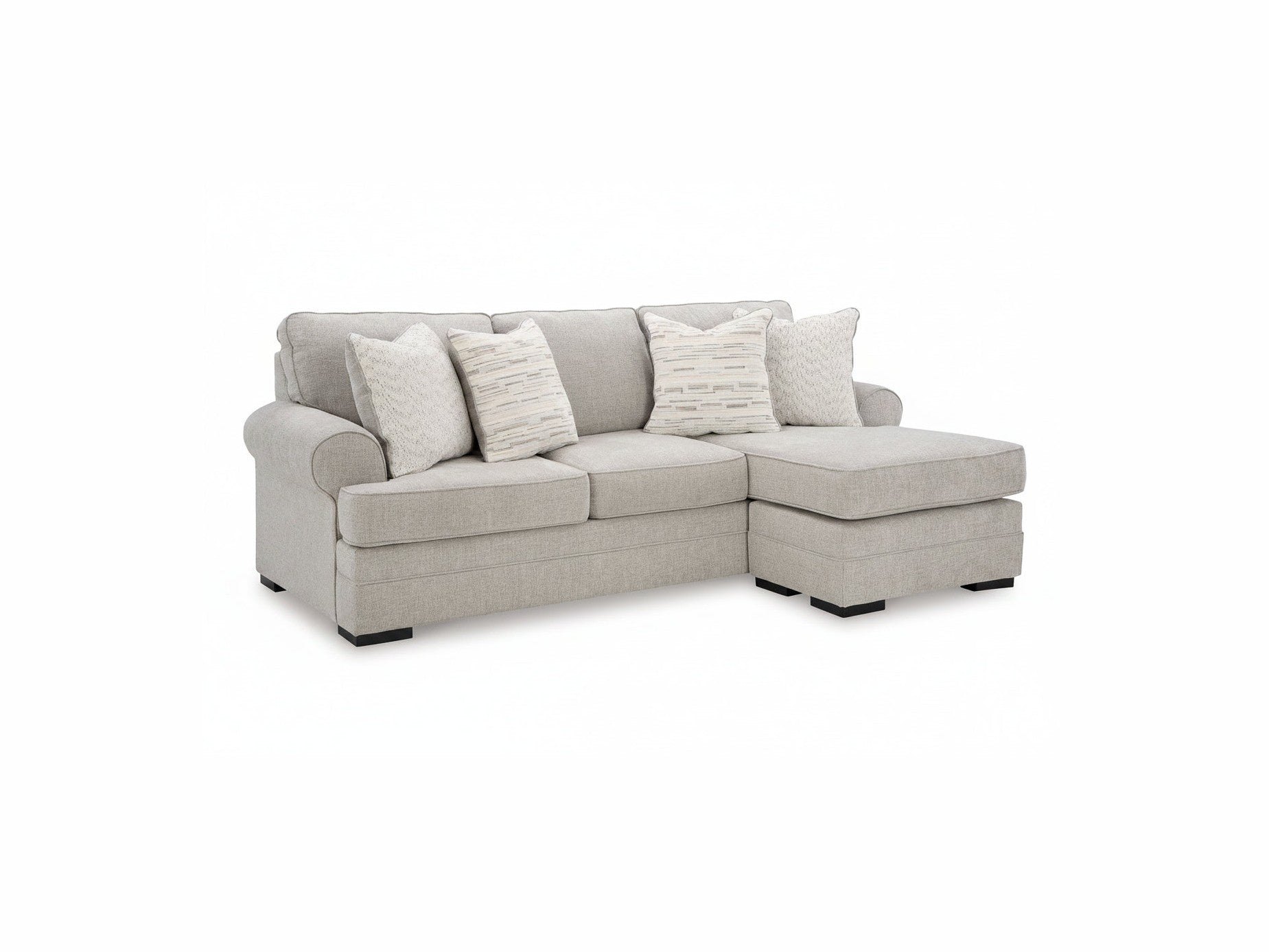 Gray sectional sofa with patterned cushions on a white background