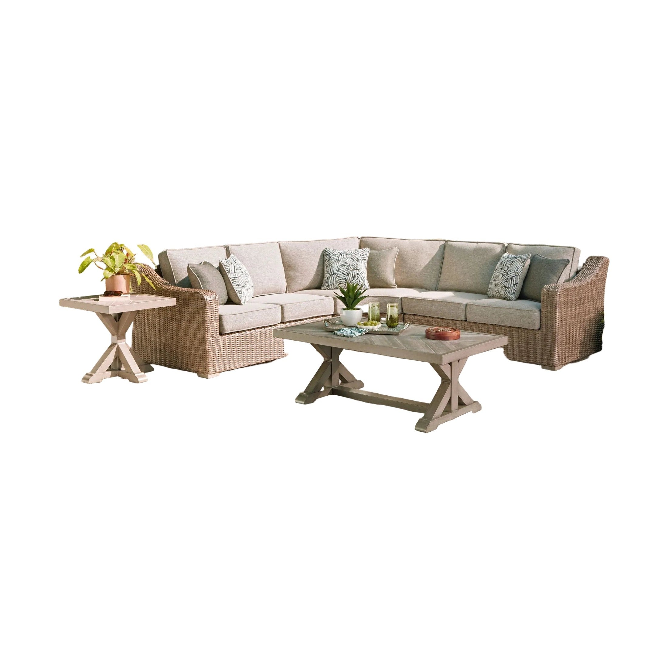 Outdoor patio set with sectional sofa, coffee table, and decorative items in a garden setting.