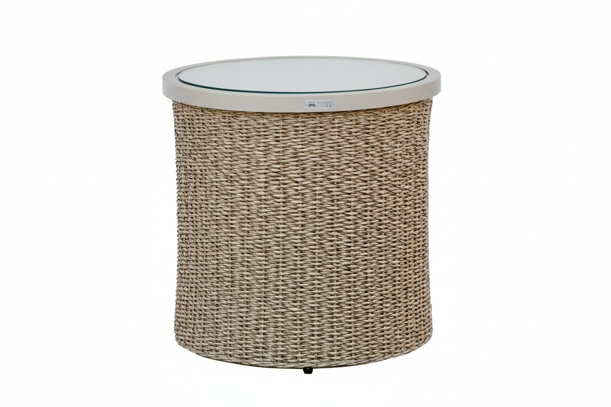 Round wicker side table with a white top on a white background