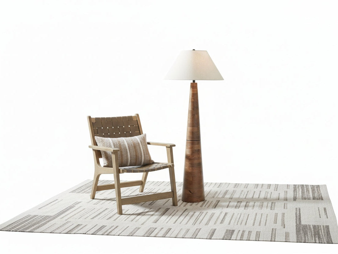 The Danset tall wooden floor lamp with a white shade in a room with a chair and plant.