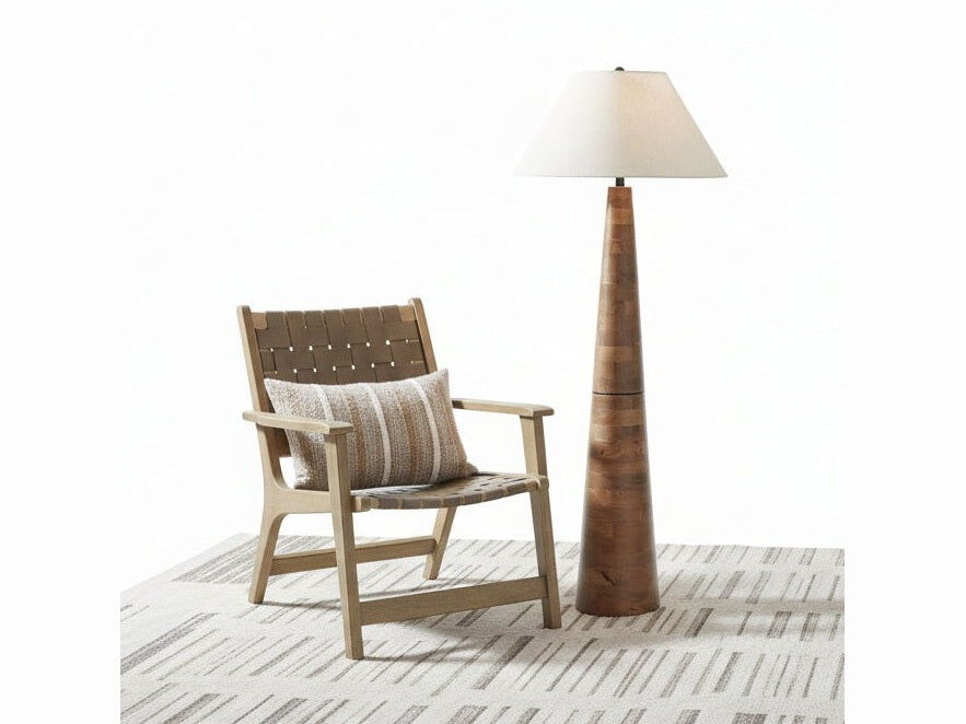 The Danset tall wooden floor lamp with a white shade in a room with a chair and plant.