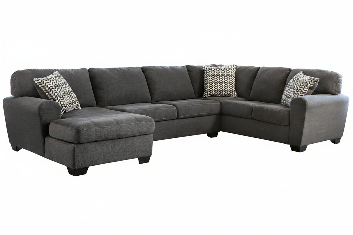 Gray sectional sofa with patterned cushions on a white background