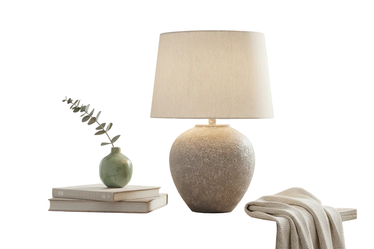 Decorative lamp with textured base and beige lampshade on a wooden surface.
