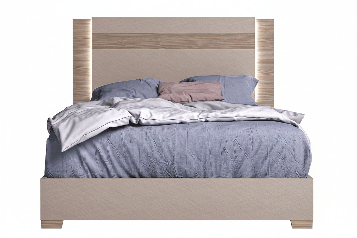 Bed with wooden headboard and bedding on a white background