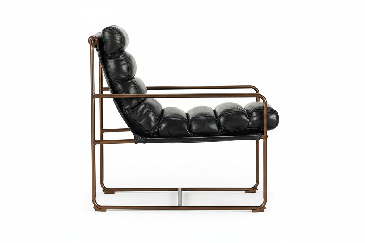Black leather lounge chair with bronze frame on a white background
