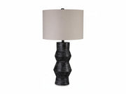 Kerbert table lamp with textured black base and beige lampshade on a white background