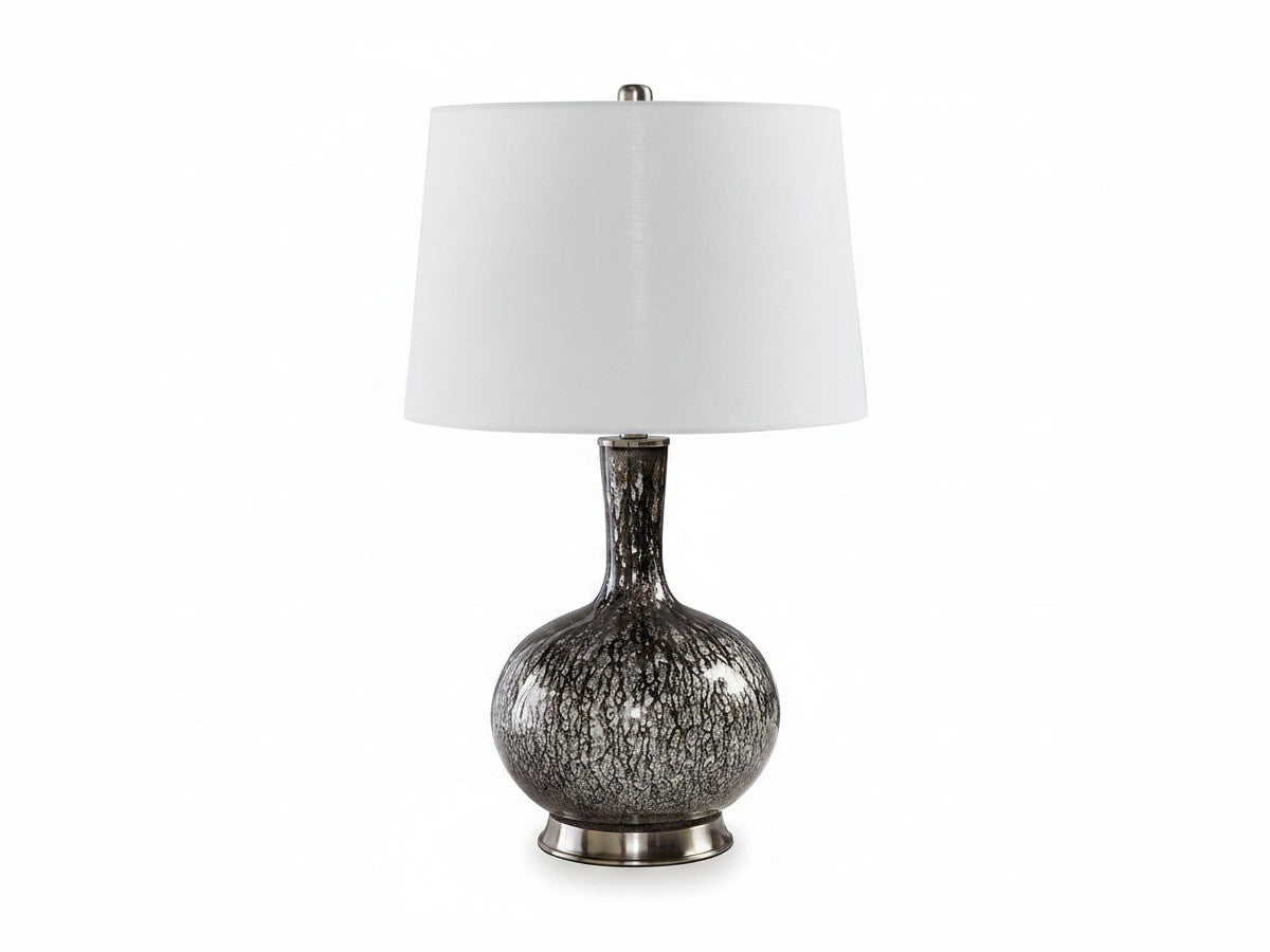 Tenslow table lamp with a textured base and white shade on a white background
