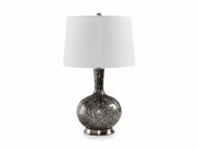 Tenslow table lamp with a textured base and white shade on a white background