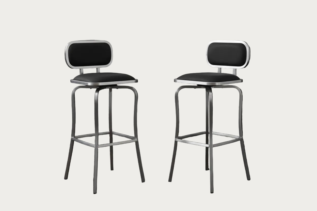 Two 1192 counter stools with black seats and backs on a white background