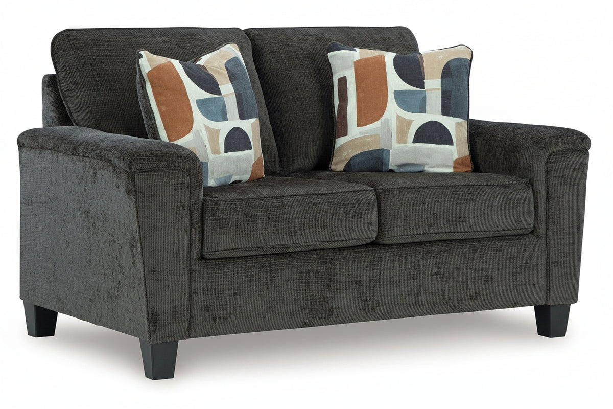 Gray sofa with two patterned cushions on a white background