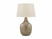 Mari table lamp with a textured ceramic base and beige lampshade on a white background.