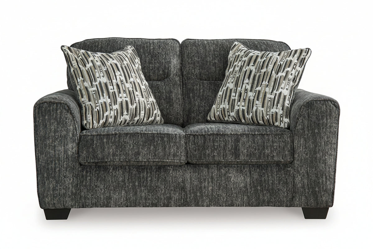 Gray sofa with patterned cushions on a white background