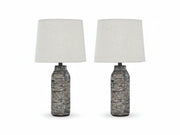 Two Mahima table lamps with textured black bases and white lampshades on a white background
