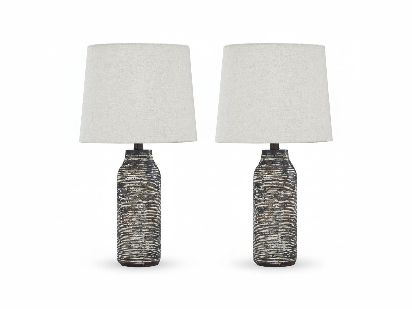 Two Mahima table lamps with textured black bases and white lampshades on a white background