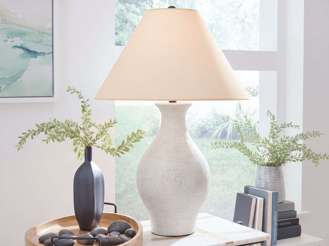Ashbend white textured table lamp on a surface with a blurred window background.