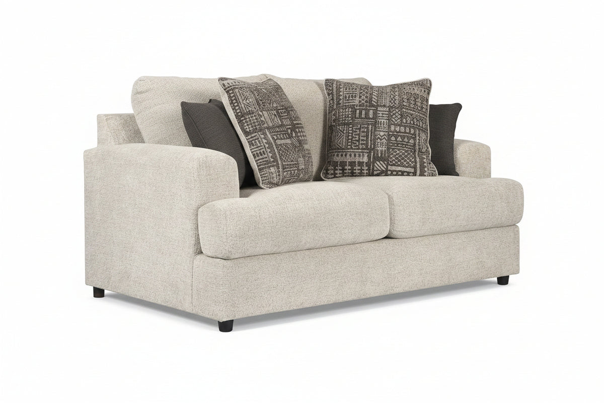 Beige sofa with patterned cushions on a white background