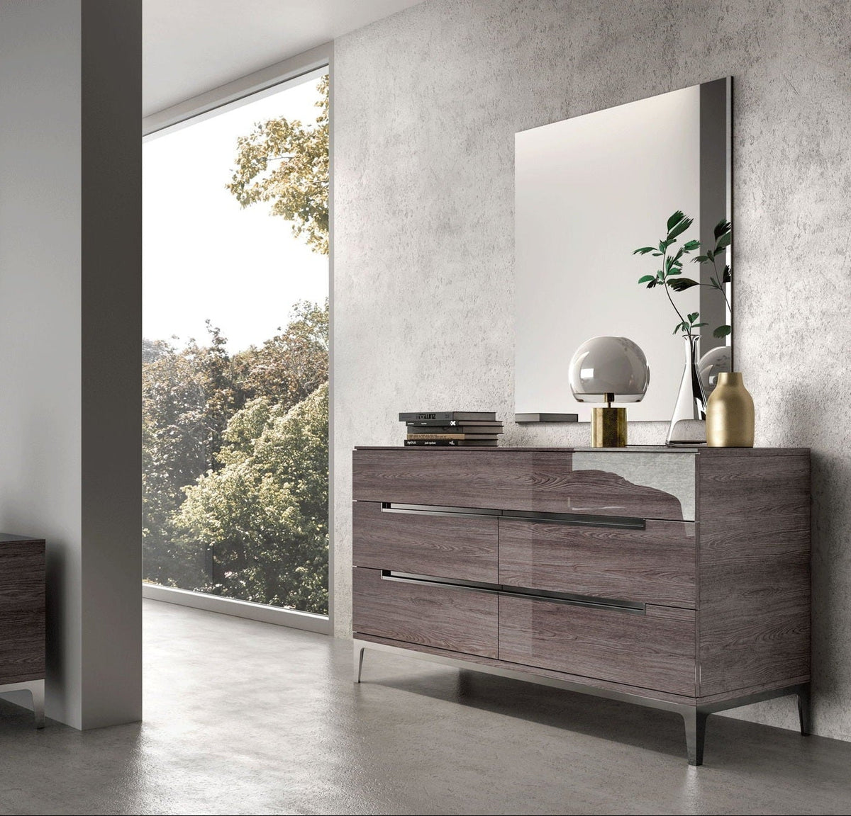 A modern gray wood dresser with a matching rectangular mirror, styled in a minimalist room with a concrete-textured wall and a large window showing trees outside.