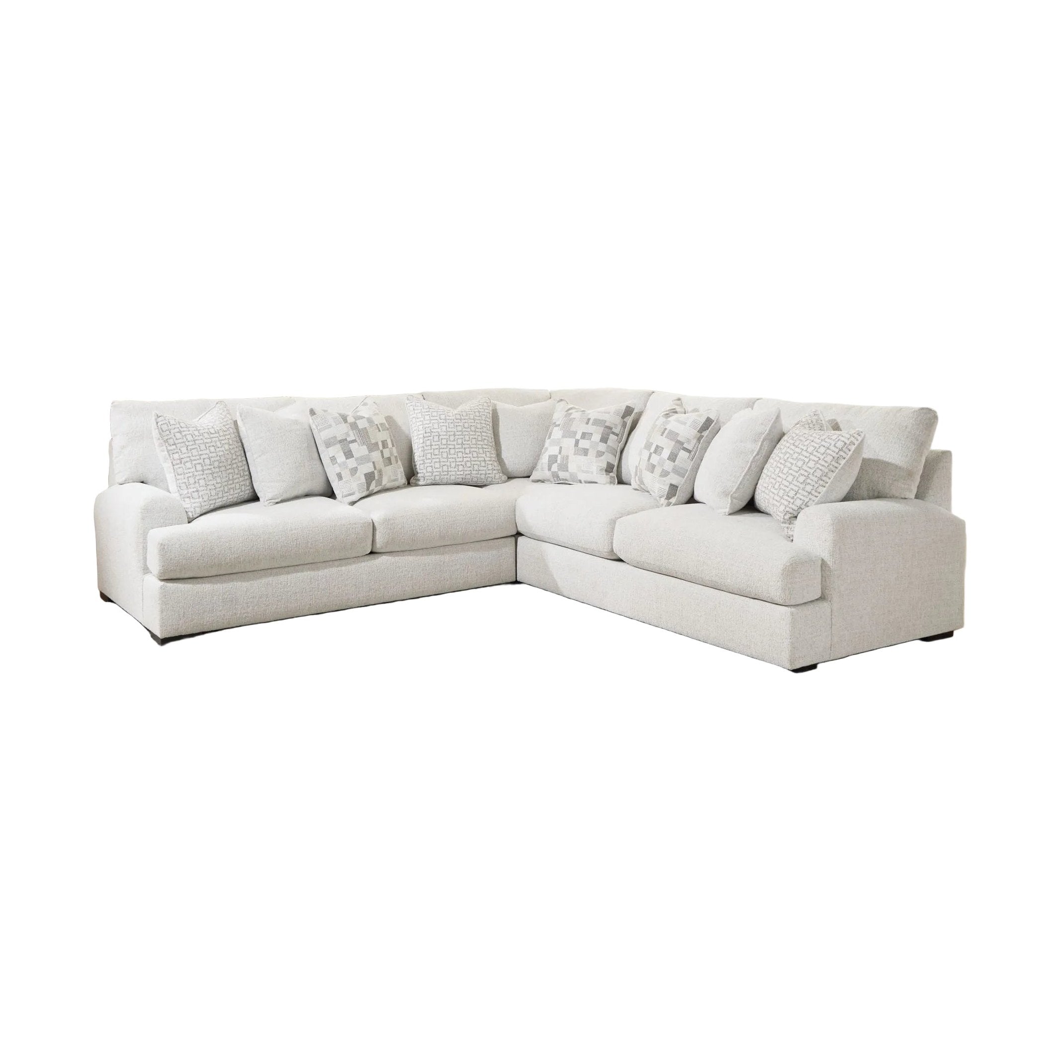 White sectional sofa with patterned cushions in a living room setting.