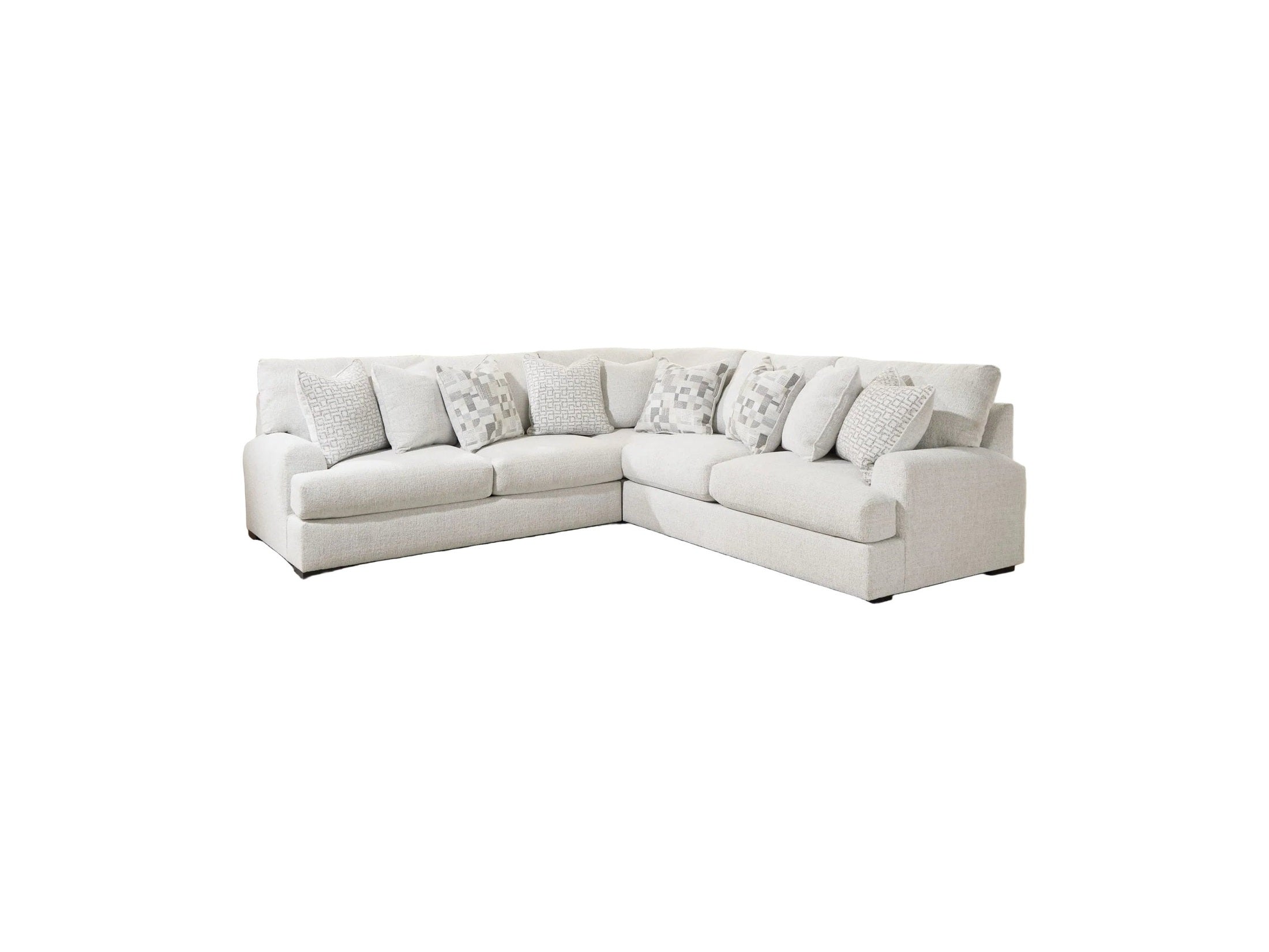 White sectional sofa with patterned cushions in a living room setting.