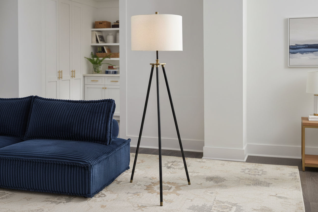 Tall floor lamp with a white shade in a living room setting.