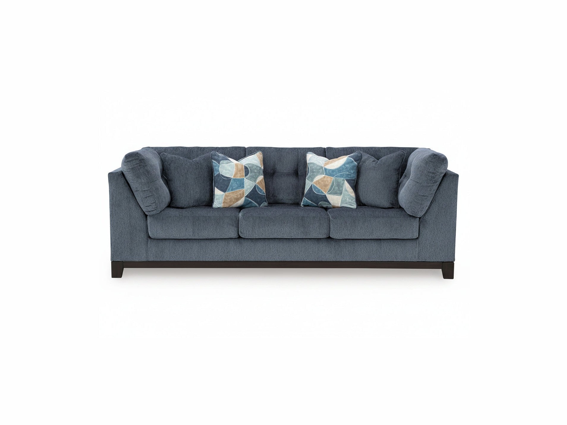 Blue sofa with patterned cushions on a white background