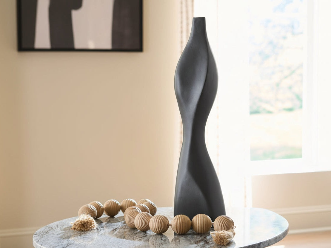 Decorative black vase on a table with a blurred background