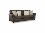 Roxmere brown leather sofa with decorative pillows on a white background.