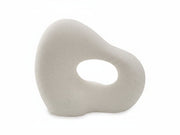 White ceramic sculpture with a circular hole on a white background
