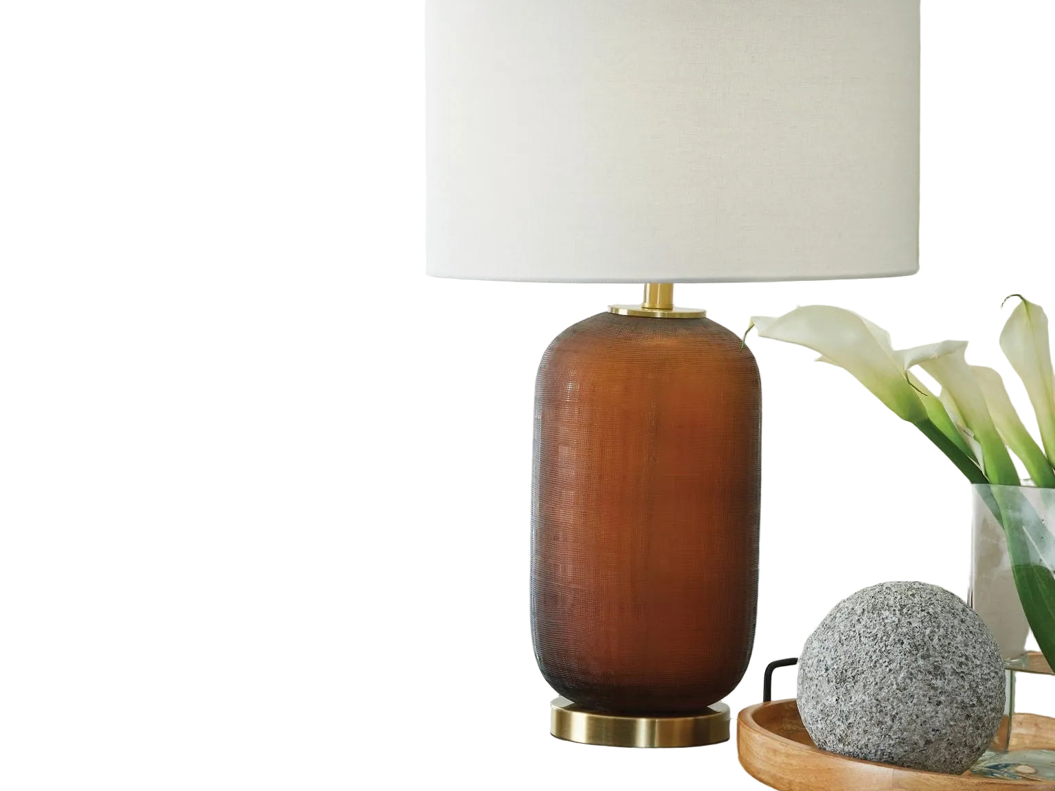 Brown table lamp with a white shade on a wooden surface near a window.
