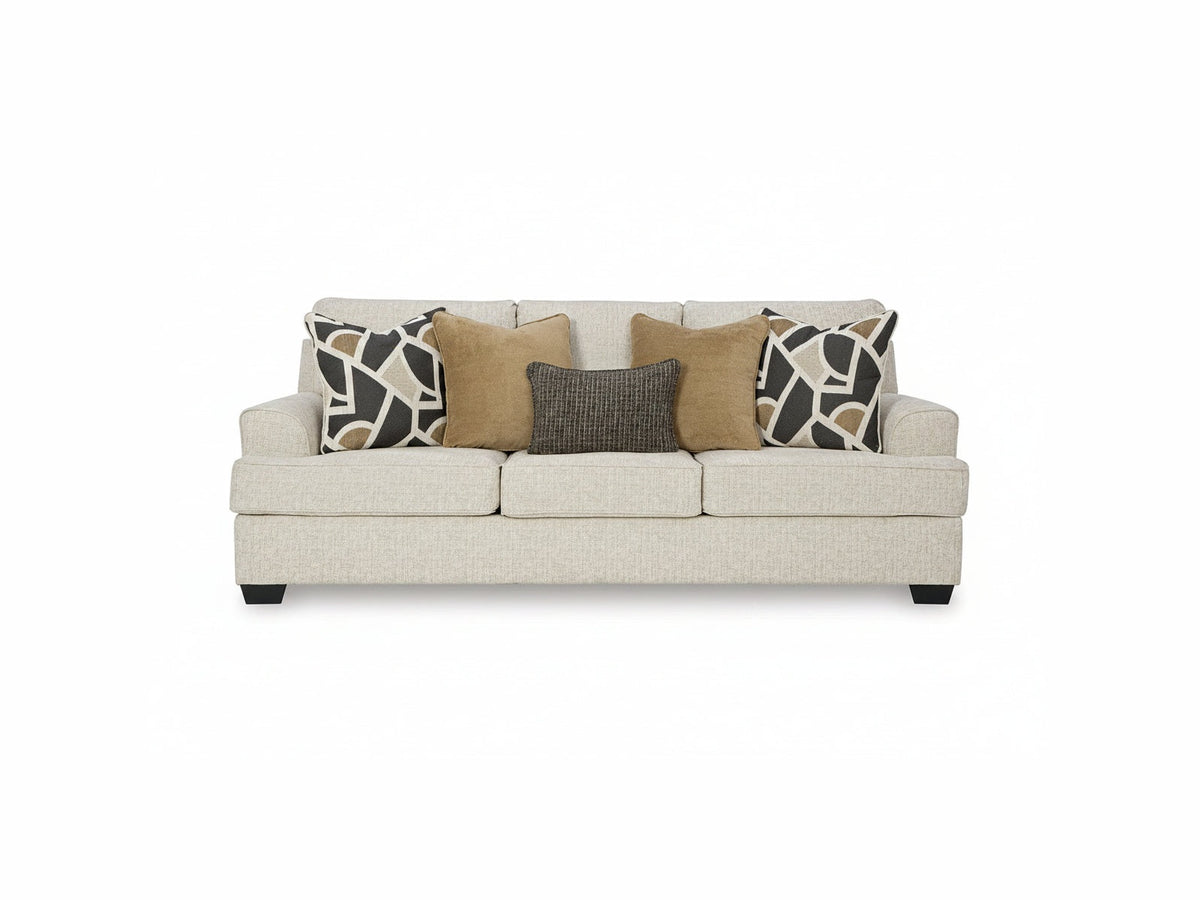 Beige sofa with patterned cushions on a white background