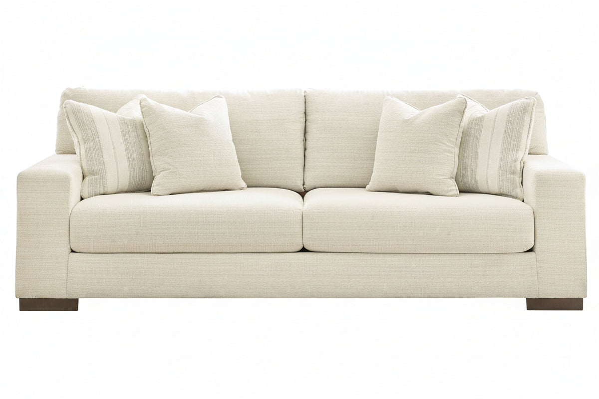 Beige sofa with striped cushions on a white background