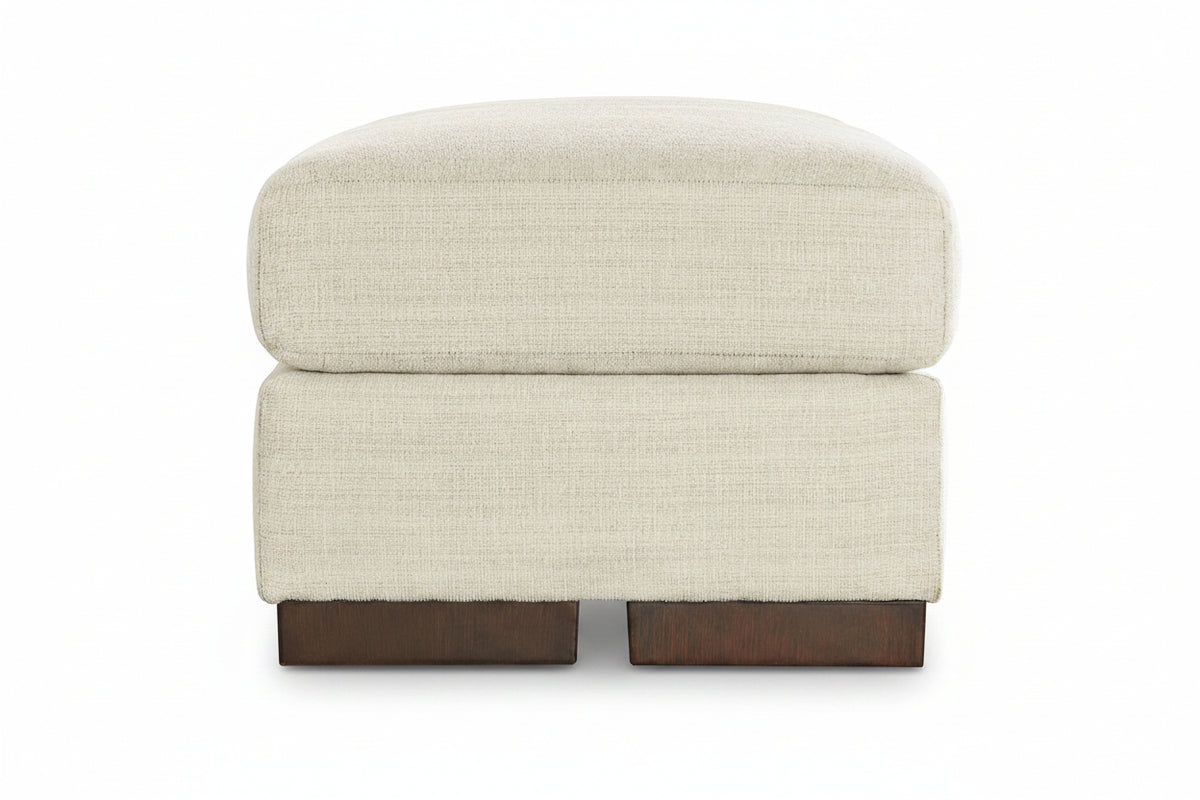 Beige ottoman with brown wooden legs on a white background