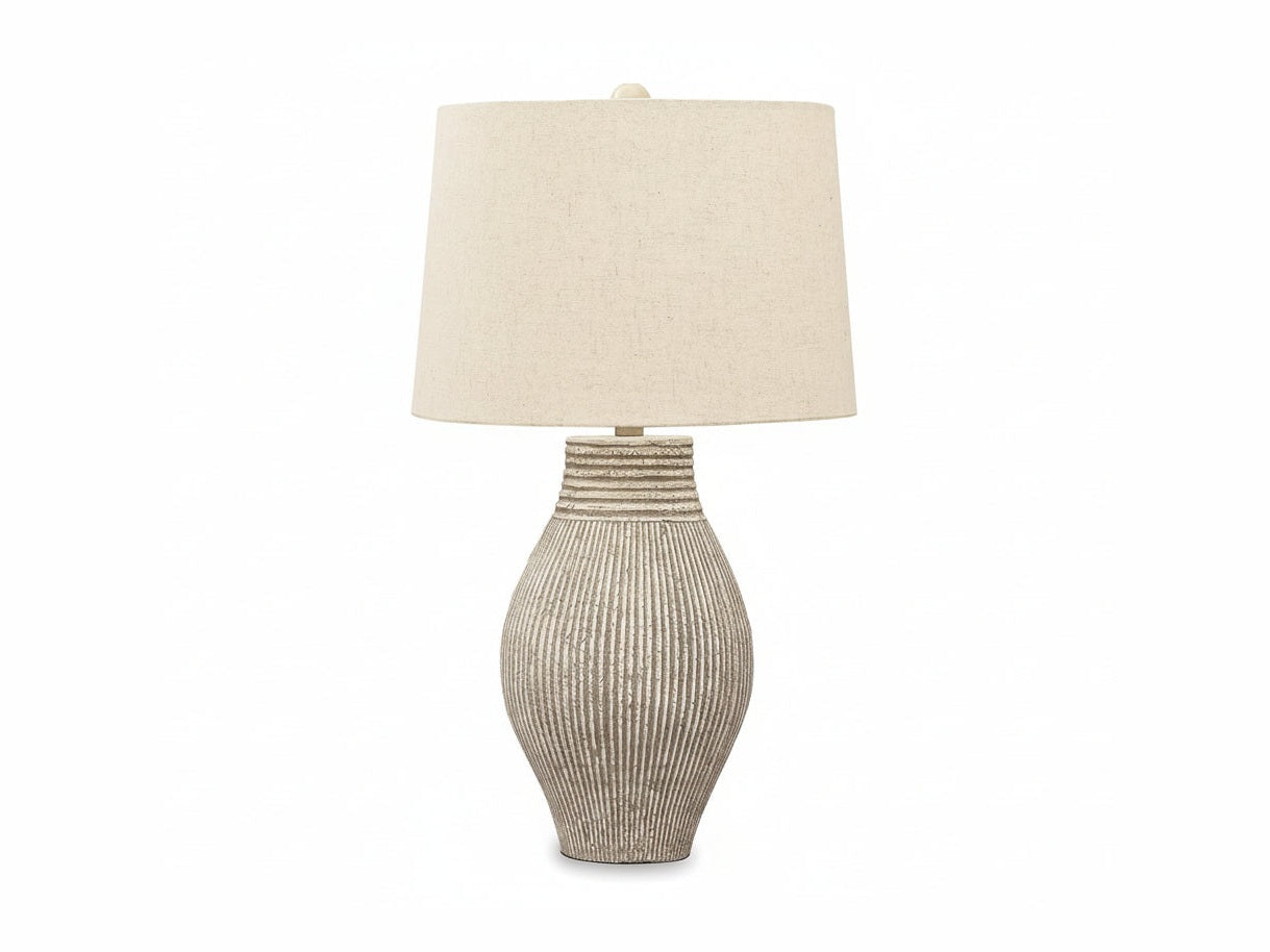 Table lamp with textured base and beige fabric shade on a white background