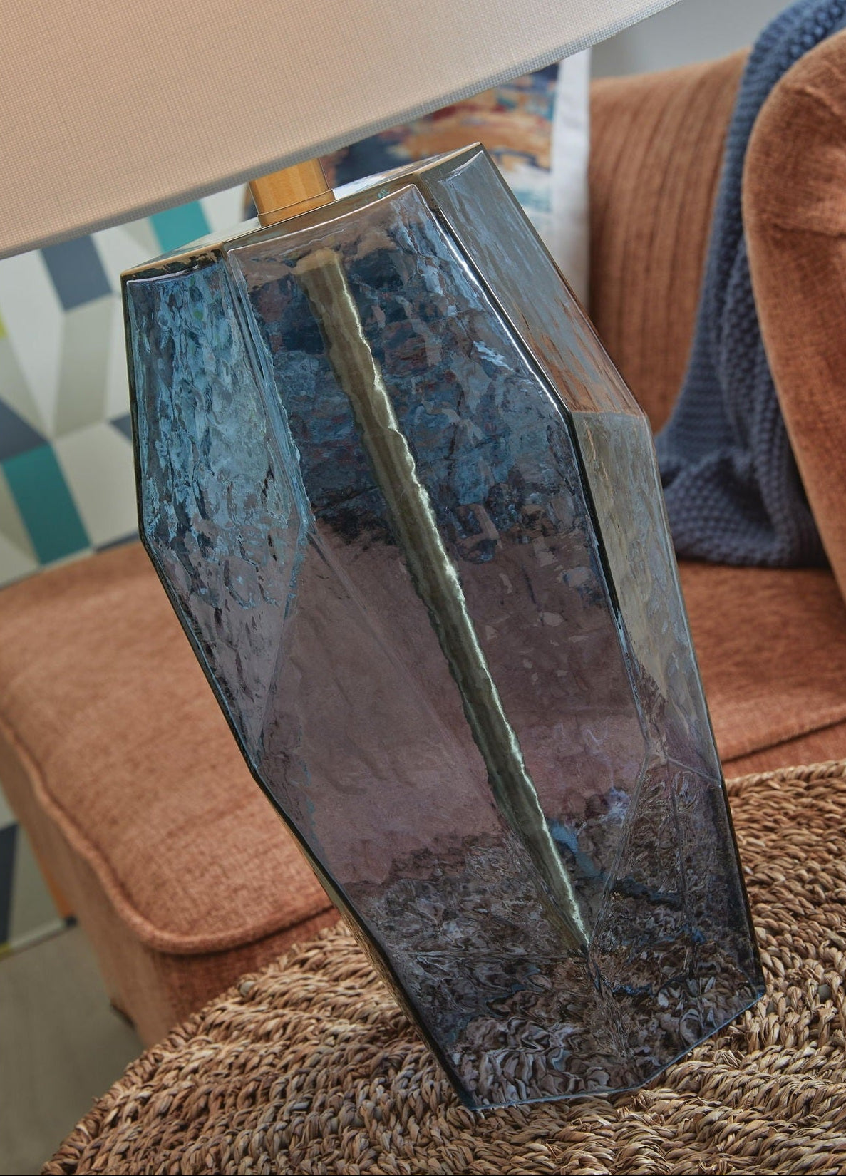 Decorative glass vase on a textured surface with a blurred background