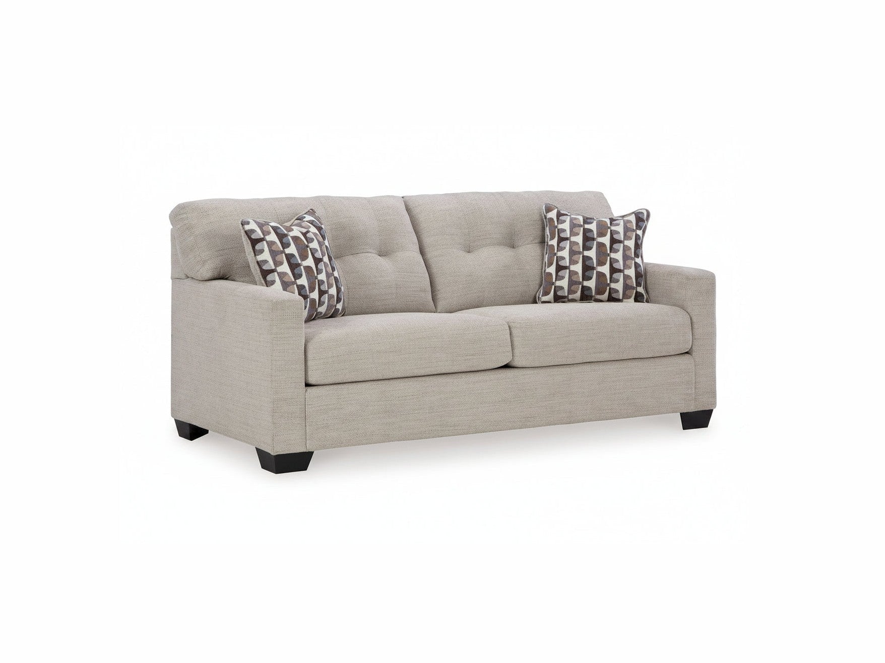 Beige sofa with two patterned pillows on a white background