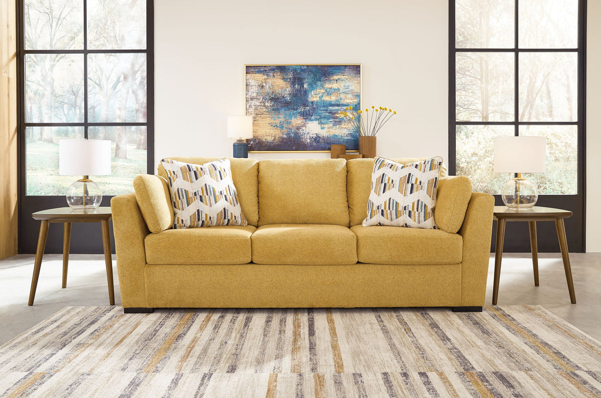 Yellow sofa with patterned cushions in a living room setting