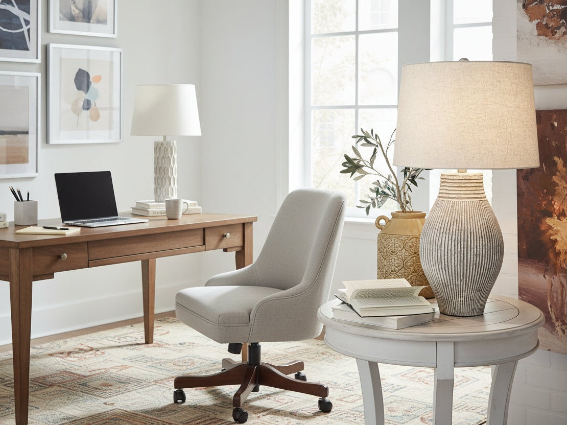 The Layal decorative lamp with a ribbed base on a table against a neutral background.
