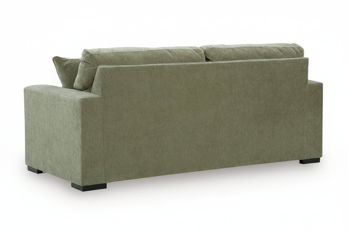 An upholstered loveseat sofa shown from the rear three-quarter angle, featuring a textured sage green fabric and dark feet, set against a plain white background.