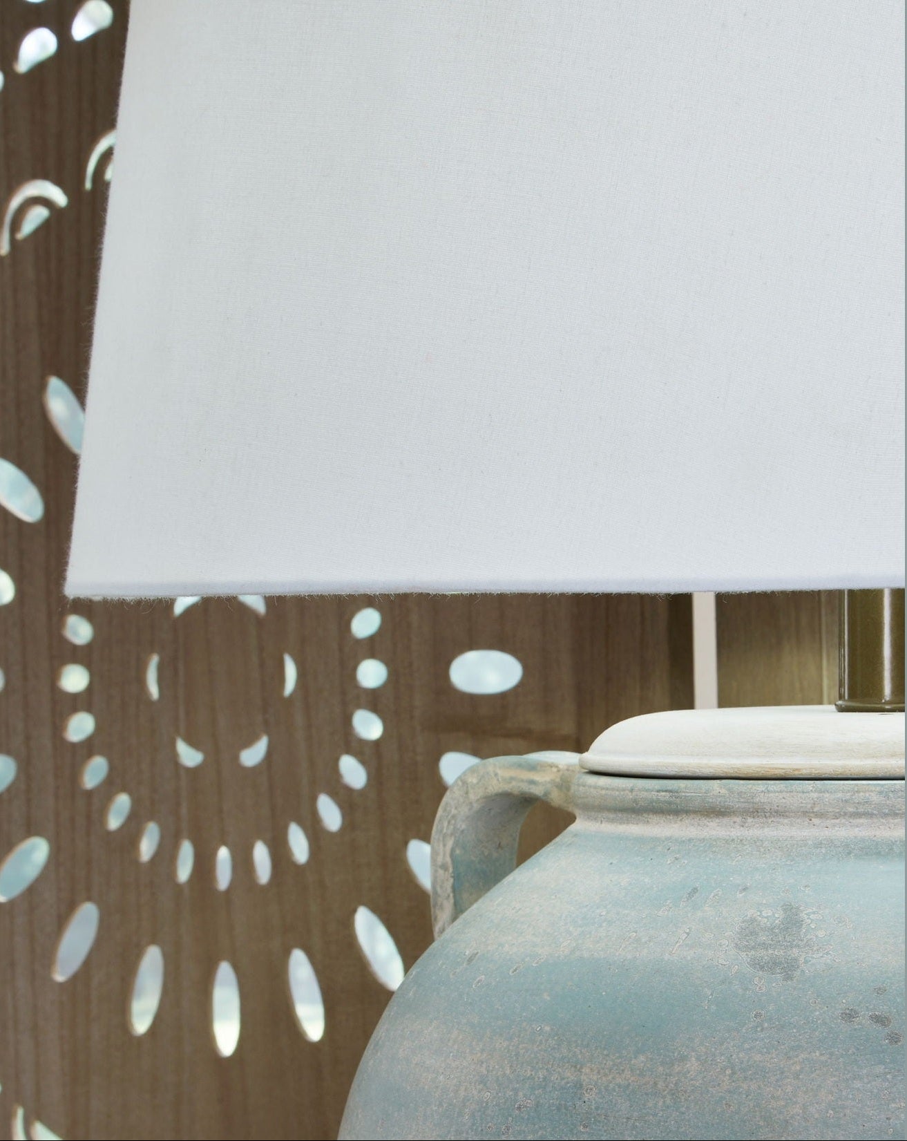 Decorative lamp with a brown patterned shade on a gray background