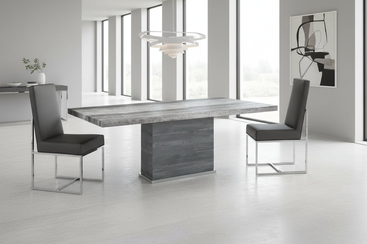 The Saturn dining table with a marble surface and two chairs in a room scene.