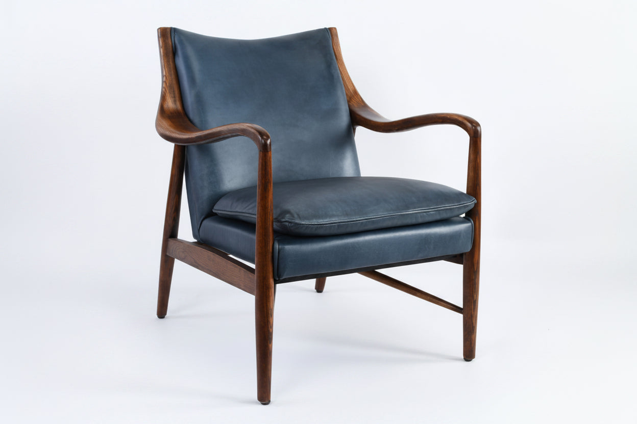 Blue leather armchair with wooden frame on a white background
