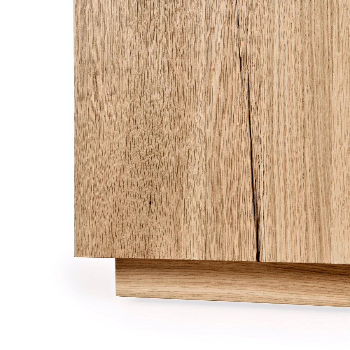 Close-up of a wooden cabinet with a light finish on a white background